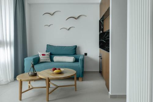 a living room with a blue couch and a table at IzaVera Luxury Suites - Vera in Heraklio