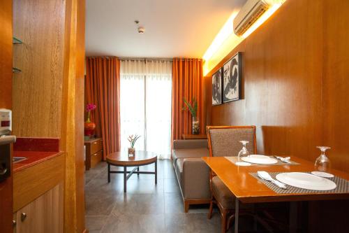 a living room with a table and a dining room at Crown Regency Beach Resort in Boracay