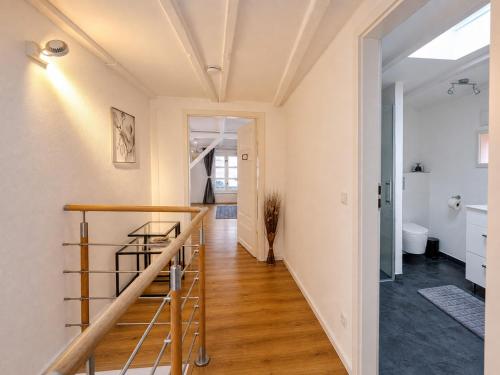 a hallway with a staircase in a house at Wismar Apartments - Cozy and Central in Wismar