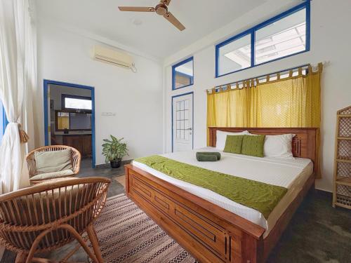 a bedroom with a large bed and a chair at Phoenix house ahangama in Ahangama