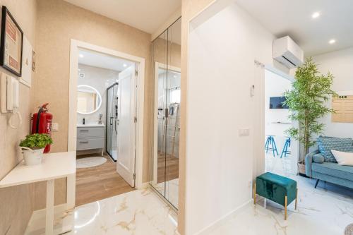 a bathroom with a glass door leading to a living room at Mar & Sol Penthouse in Portimão