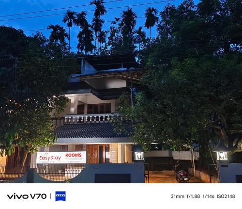a building with a sign on the side of it at Easystayhomestay in Kunnamangalam