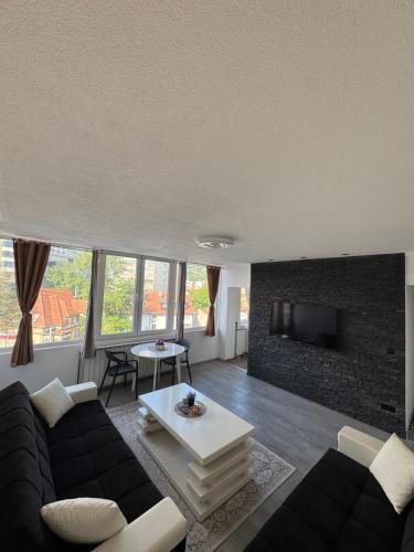 a living room with a couch and a fireplace at Apartman Tuzla in Tuzla