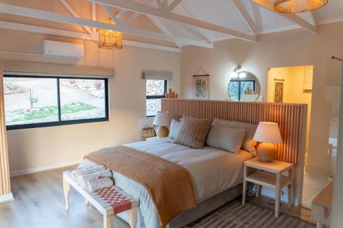 a bedroom with a large bed and a window at Nicara Luxury Ecocabin Honeypunch in Keysers