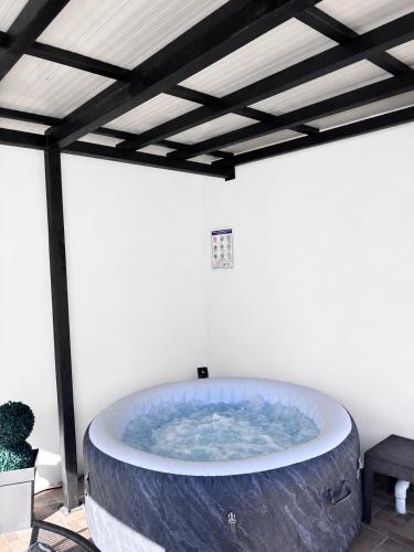 a large bath tub in a room with a ceiling at Apartmani Nil in Barić Draga