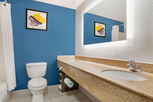 a bathroom with a toilet and a sink at Comfort Inn & Suites Dothan Northside Plaza in Dothan