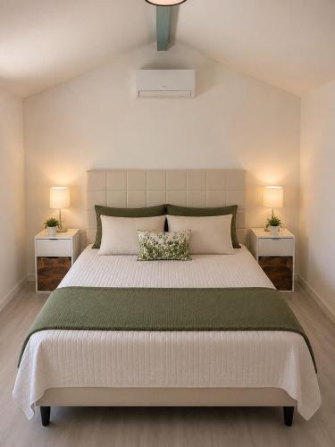a bedroom with a large bed with two night stands at La Escapade Cubaine in Villeneuve-sur-Lot