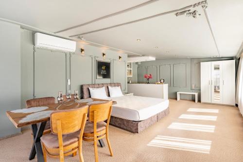 a bedroom with a bed and a table and chairs at Marine Point Hotel & Antalya in Antalya