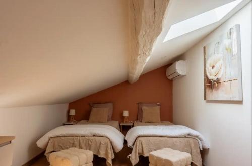 a attic bedroom with two beds and a skylight at Azure méditerranée in Sérignan