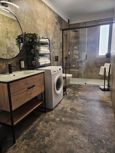 a bathroom with a washing machine in a sink at Akacjowa 11 in Skorochow