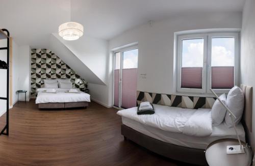a bedroom with two beds and two windows at Akacjowa 11 in Skorochow