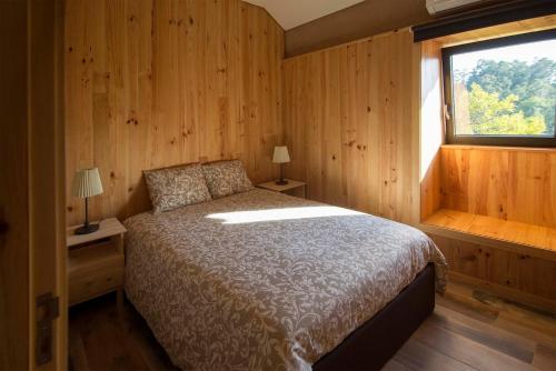 a bedroom with a bed and a window at Welcome to Gerês in Ventosa