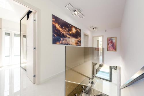 a glass elevator in a house with a painting on the wall at Villas Weiss in Vir