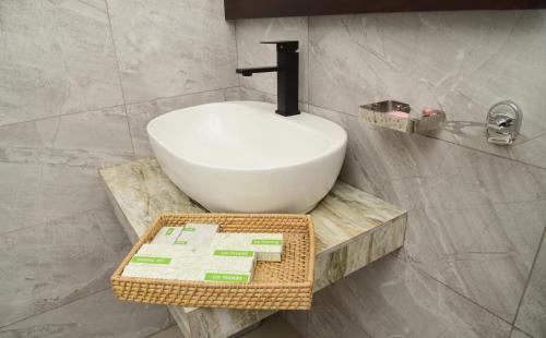 a bathroom with a white bowl on a wooden table at Ever Breeze Ella Hotel in Ella