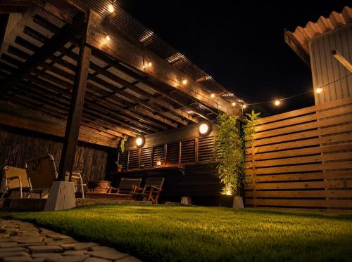 a patio at night with lights on it at 民泊やがみ-Yagami- in Sanagu