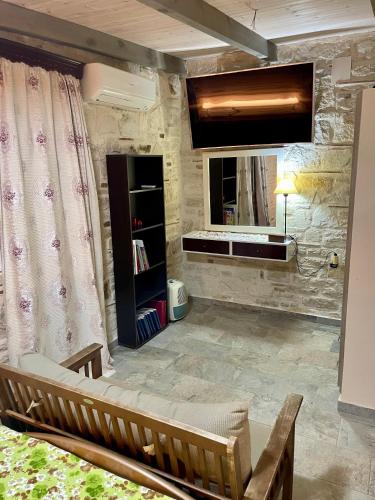 a living room with a couch and a mirror at Mersini Village in Milonianá