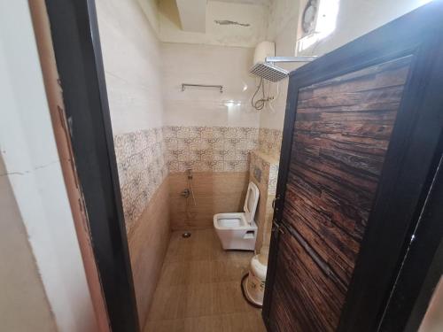 a small bathroom with a toilet and a shower at mythriinn in Araku