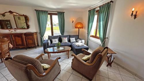 a living room with a couch and a table and chairs at Le gîte de montréal in Saint-Germain-les-Belles