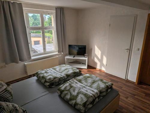 a living room with two ottomans in front of a window at Stadt Hamburg in Lenzen