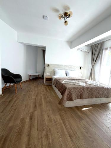 a bedroom with a bed and a ceiling fan at ThasosGoldenStay in Skala Potamias