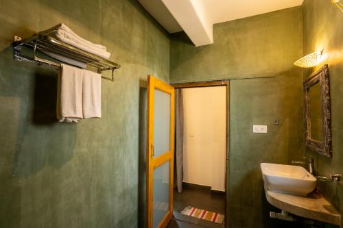 a bathroom with a sink and a mirror at Alpa Viram Retreat Goa in Mandrem