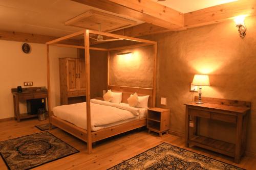 a bedroom with a canopy bed in a room at Kainchi Boutique Homestay in Rāmgarh
