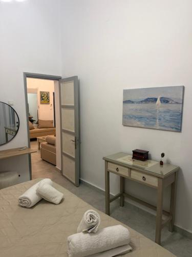 a room with a desk and a bed and a mirror at Casa Maritina Gennadi Traditional House in Gennadi