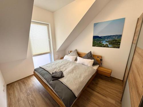 a bedroom with a bed and a large window at Ferienwohnanlage Einzigartig in Saarburg