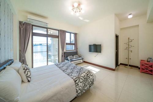 a bedroom with a large bed and a tv in it at Rain Sun Homestay in Ji'an