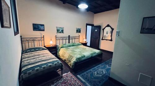 a bedroom with two beds and a mirror on the wall at Residence Oasi del Delta in Taglio di Po