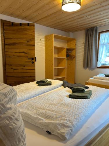 two beds in a room with wooden walls at Appart Alte Post in Partenen