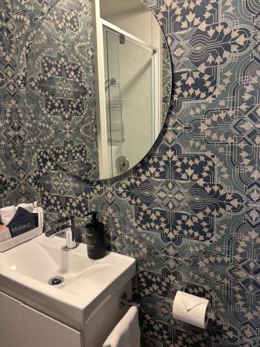 a bathroom with a sink and a mirror at The Opera View Suite in Oamaru