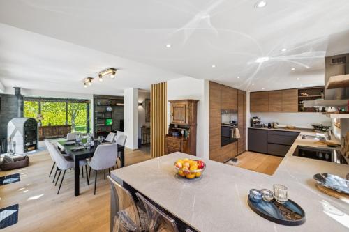 a kitchen and living room with a table and chairs at Chalet Niva by Mrs Miggins in Lens