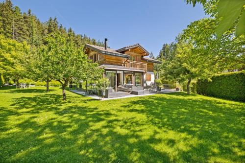 a house with a large lawn in front of it at Chalet Niva by Mrs Miggins in Lens