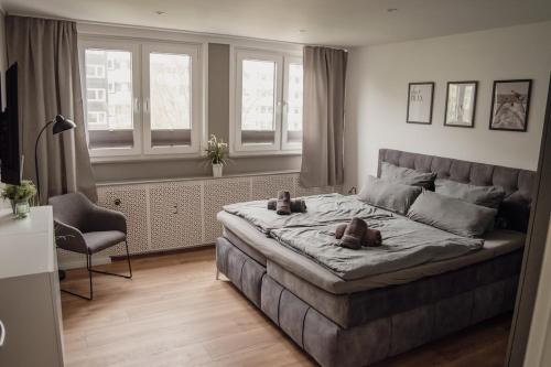 a bedroom with a large bed with two teddy bears on it at Apartment Claussen 2 in Bremerhaven