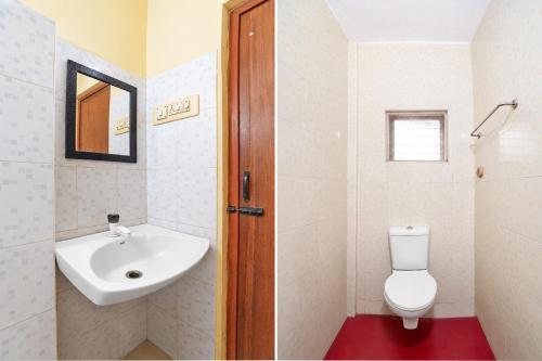 a white bathroom with a sink and a toilet at FabHotel Nimalan Residency Tambaram in Chennai