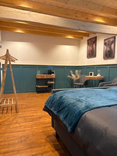 a bedroom with a bed and a wooden floor at Vue sur la colline La-Roche in Bouzais