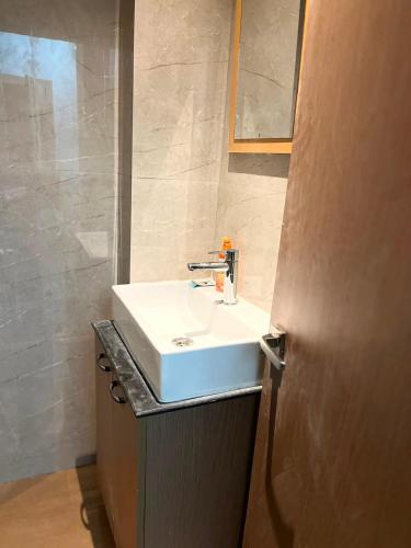 a bathroom with a white sink and a mirror at AS Living Guest House - A boutique stay near Apollo Hospital, City Center Mall, PhysicsWallah, Allen, SPM in Guwahati