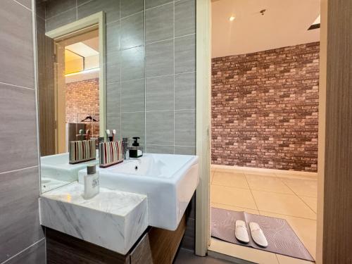 a bathroom with a white sink and a tub at ICON CITY PETALING JAYA By WeCare in Petaling Jaya