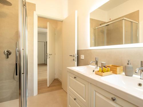 a bathroom with a sink and a mirror and a shower at Casa Rita - Casa vacanze - free parking terrazze e giardino area barbecue TOP CLASS in Predore