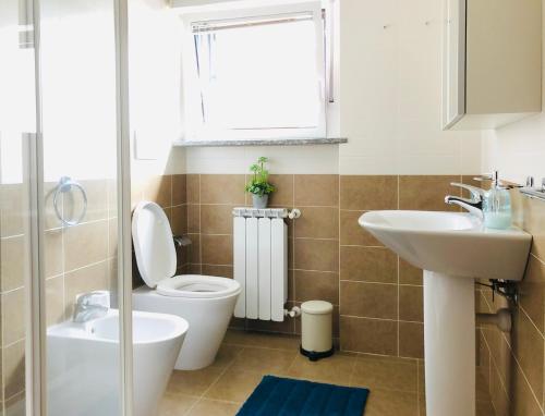 a bathroom with a toilet and a sink at Stepandgo Milano Navigli in Milan
