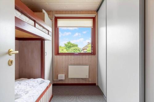 a bedroom with a window and a bunk bed at 2218-Ringkobing-Milevej-22 in Klegod