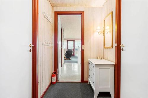 a hallway with a bathroom with a sink and a mirror at 2218-Ringkobing-Milevej-22 in Klegod