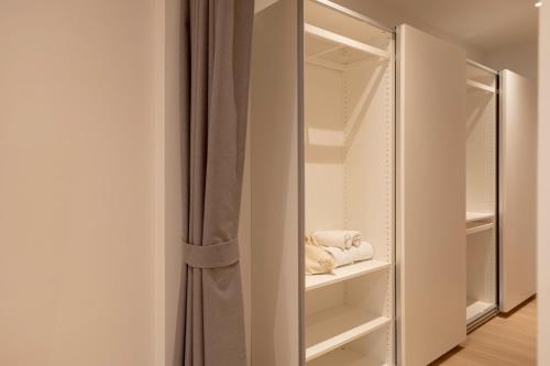 a walk in closet with a mirror and towels at Taupe Hotel in Chiang Mai