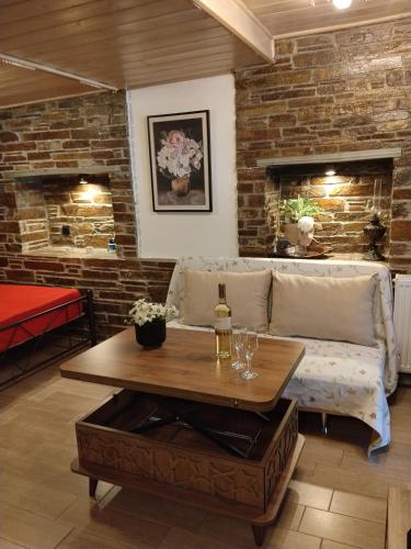 a living room with a couch and a table at villa lena πετρινο in Katákoilos