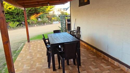a black table and chairs on a patio at Cabañas La Campiña Algarrobo in Algarrobo