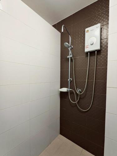 a shower in a bathroom with black and white tiles at Condo in Hua Hin in Hua Hin