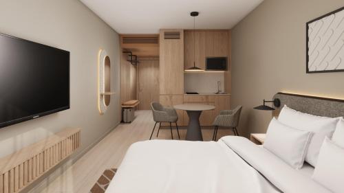 a hotel room with a bed and a flat screen tv at Wellton Riga Hotel & SPA in Riga