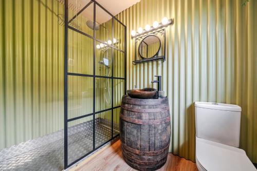 a bathroom with a barrel sink and a toilet at Bwncath in Welshpool