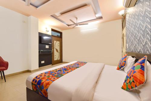a bedroom with a large bed and a television at FabHotel Moon Stone, Near Jawahar Circle - World Trade Park in Jaipur